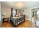 Comfortable bedroom featuring hardwood floors, a striking light fixture, and two windows at 904 Anderson St, Charlotte, NC 28205