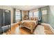 Cozy bedroom with a comfortable bed, two windows, and hardwood flooring at 904 Anderson St, Charlotte, NC 28205