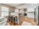 Open concept dining area with bar seating, view of the kitchen, and hardwood floors at 904 Anderson St, Charlotte, NC 28205