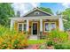 Inviting mustard-color home exterior surrounded by blooming flowers at 904 Anderson St, Charlotte, NC 28205
