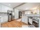 Bright kitchen with stainless steel appliances, white cabinets and backsplash, and hardwood floors at 904 Anderson St, Charlotte, NC 28205