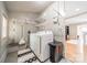 Functional laundry room with washer, dryer, wire shelves, and easy access to other rooms at 904 Anderson St, Charlotte, NC 28205