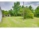 Large backyard with lush green grass, a shed and mature shade trees at 976 Neely Store Rd, Rock Hill, SC 29730