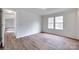 Bright bedroom featuring two windows and wood-look vinyl flooring at 976 Neely Store Rd, Rock Hill, SC 29730