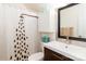 Bathroom featuring a decorative shower curtain, vanity and mirror with nice lighting at 10209 Green Tee Ln, Charlotte, NC 28277