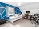 A bedroom with an interesting accent wall and an area set up for study or music at 10209 Green Tee Ln, Charlotte, NC 28277