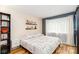Inviting bedroom with a decorative wall, wood floors, and natural light from a window at 10209 Green Tee Ln, Charlotte, NC 28277