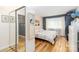 Cozy bedroom features natural light, wood flooring, a closet, and neutral decor at 10209 Green Tee Ln, Charlotte, NC 28277