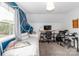 Bedroom with a bed, study area, and a blue accent wall at 10209 Green Tee Ln, Charlotte, NC 28277
