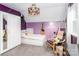 Well lit bedroom with bright purple walls, a closet, and a comfy lounge chair at 10209 Green Tee Ln, Charlotte, NC 28277
