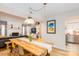 Bright dining room featuring a wooden table, hardwood floors, and modern lighting at 10209 Green Tee Ln, Charlotte, NC 28277