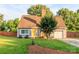 Charming home featuring a well-manicured lawn, freshly painted siding, and inviting, bright yellow front door at 10209 Green Tee Ln, Charlotte, NC 28277