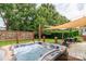 Unwind in the hot tub overlooking the backyard with privacy fence and shade sails at 10209 Green Tee Ln, Charlotte, NC 28277