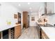 Bright kitchen with modern appliances, two tone cabinets, wine fridge and lots of counter space at 10209 Green Tee Ln, Charlotte, NC 28277