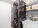 Laundry room with stacked washer and dryer plus utility sink and shelving at 10209 Green Tee Ln, Charlotte, NC 28277