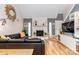 Bright living room showcasing a stone fireplace, hardwood floors, and a comfortable seating arrangement at 10209 Green Tee Ln, Charlotte, NC 28277
