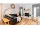 Cozy living room with a stone fireplace, hardwood floors, and a comfortable leather sofa at 10209 Green Tee Ln, Charlotte, NC 28277
