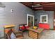 A covered patio with comfortable seating and a view of the backyard at 10209 Green Tee Ln, Charlotte, NC 28277