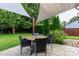 Enjoy outdoor dining under a shade sail on the stamped concrete patio at 10209 Green Tee Ln, Charlotte, NC 28277