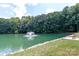 A pond featuring a fountain surrounded by lush trees and greenery at 10209 Green Tee Ln, Charlotte, NC 28277