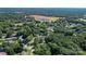 An aerial view showing residential properties nestled among lush green trees and vegetation in the surrounding area at 1072 5Th Ne St, Hickory, NC 28601