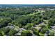 An aerial view showing residential properties with lush green trees and vegetation in the surrounding area at 1072 5Th Ne St, Hickory, NC 28601