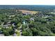 Aerial view showcasing the property nestled among mature trees near local amenities at 1072 5Th Ne St, Hickory, NC 28601