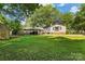 Spacious backyard featuring a lush lawn, storage shed, and convenient carport at 1072 5Th Ne St, Hickory, NC 28601