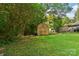 Spacious backyard featuring a lush lawn, wooden storage shed, and convenient carport at 1072 5Th Ne St, Hickory, NC 28601