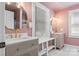 Stylish bathroom featuring double vanities, unique lighting fixtures, and a modern design with pink walls at 1072 5Th Ne St, Hickory, NC 28601