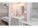 Charming bathroom featuring unique lighting, gold fixtures, and a modern design with pink walls at 1072 5Th Ne St, Hickory, NC 28601