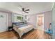 Comfortable bedroom with hardwood floors, a ceiling fan, and access to an ensuite bathroom at 1072 5Th Ne St, Hickory, NC 28601