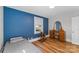 Cozy bedroom featuring laminate floors, neutral walls, a fun blue accent wall and natural light at 1072 5Th Ne St, Hickory, NC 28601