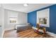 Cozy bedroom featuring laminate floors, neutral walls, a fun blue accent wall and natural light at 1072 5Th Ne St, Hickory, NC 28601