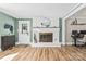 Bright living room with a white brick fireplace, hardwood floors, and neutral wall color at 1072 5Th Ne St, Hickory, NC 28601