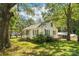 Inviting home with green lawn and carport, framed by mature trees at 1072 5Th Ne St, Hickory, NC 28601