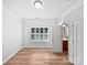 Bedroom with hardwood floors, a window with plantation shutters, and ensuite access to bathroom at 1090 Mclaren Dr, Belmont, NC 28012