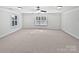 Spacious bedroom with neutral carpet, white trim, windows, and ceiling fan at 1090 Mclaren Dr, Belmont, NC 28012