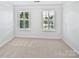 Bright room with fresh carpet and multiple windows with light shining through at 1090 Mclaren Dr, Belmont, NC 28012