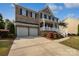 Attractive brick home with a two-car garage, manicured landscaping and a welcoming front porch at 1090 Mclaren Dr, Belmont, NC 28012