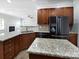 Open kitchen featuring granite countertops, stainless steel appliances, and a central island at 1090 Mclaren Dr, Belmont, NC 28012