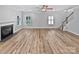 Open living room showcasing a fireplace, stairs, hardwood floors and great natural light at 1090 Mclaren Dr, Belmont, NC 28012