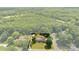 An aerial view highlights a single Gathering home and the surrounding wooded land included with the property at 111 Kelly Ln, Gastonia, NC 28056