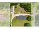 This aerial view shows the home, detached garage and a paved area adjacent to the extra long driveway at 111 Kelly Ln, Gastonia, NC 28056