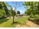 A sprawling backyard with a partially obscured view of the house and fence line at 111 Kelly Ln, Gastonia, NC 28056