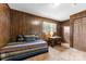 The bedroom features wood paneled walls, carpet, and a window for natural light at 111 Kelly Ln, Gastonia, NC 28056