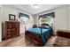 Comfortable bedroom featuring a four-poster bed, natural light, and traditional furnishings at 111 Kelly Ln, Gastonia, NC 28056