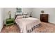 A cozy bedroom with hardwood flooring, a queen bed, and ample natural light at 111 Kelly Ln, Gastonia, NC 28056
