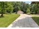 A long driveway leads to a detached garage with a golf cart parked nearby at 111 Kelly Ln, Gastonia, NC 28056