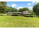 Charming two-story home with brick and siding exterior, lush front lawn and mature trees at 111 Kelly Ln, Gastonia, NC 28056